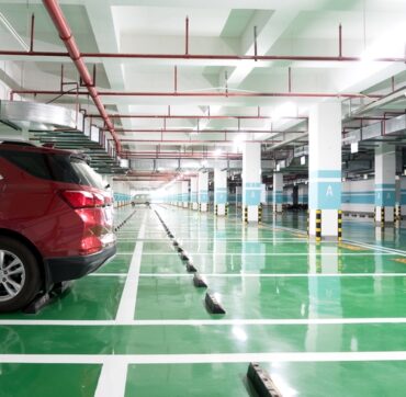 interior of parking garage with car and vacant parking lot in parking building