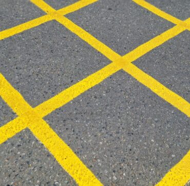 medium-vecteezy_a-yellow-grid-applied-to-a-gray-road-surface-this-markup_86577414_medium